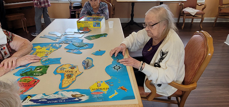 Residents working together to assemble puzzle