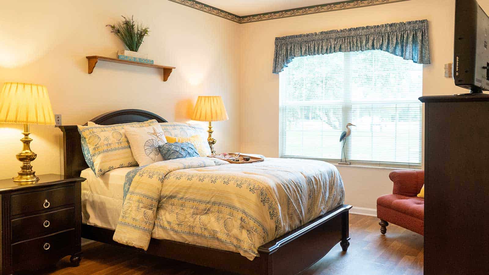 Fully furnished bedromm with large bed, end tables with lamps and a large window at Superior Residence of Brandon